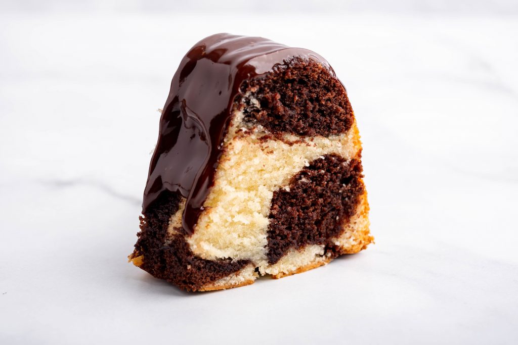 Slice of marble cake showing the vanilla and chocolate swirl
