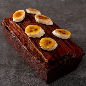 Chocolate banana bread topped with halved bananas