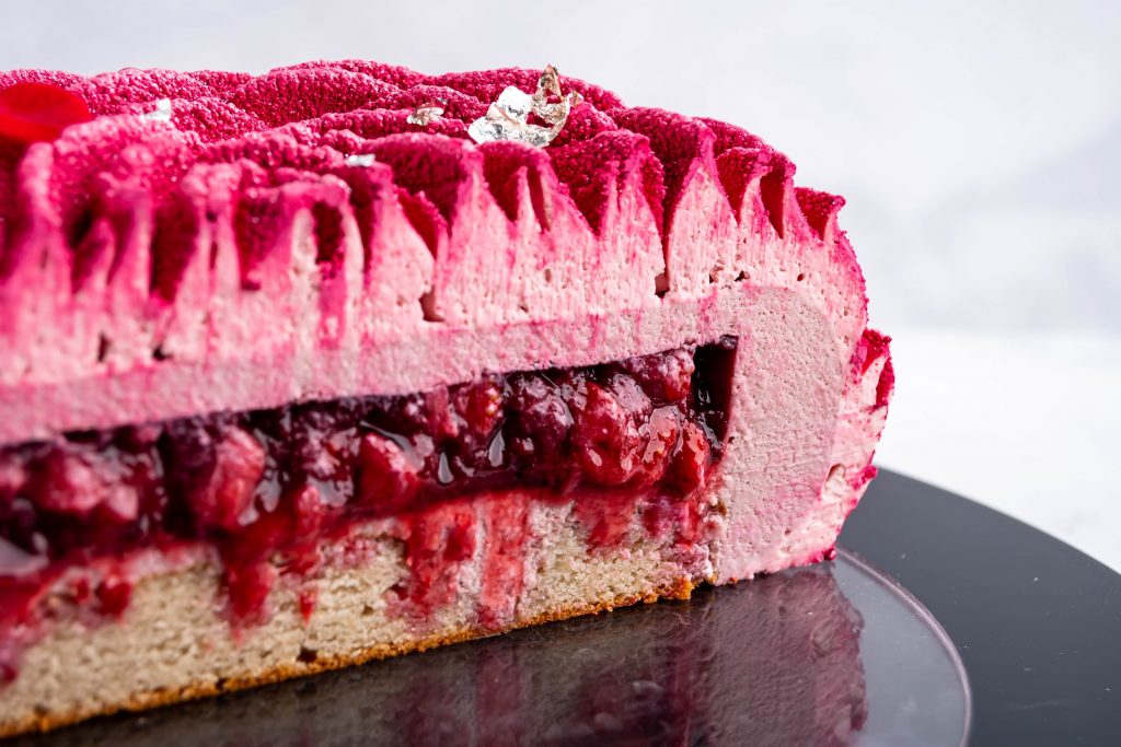 Slice of ruby chocolate and strawberry entremet