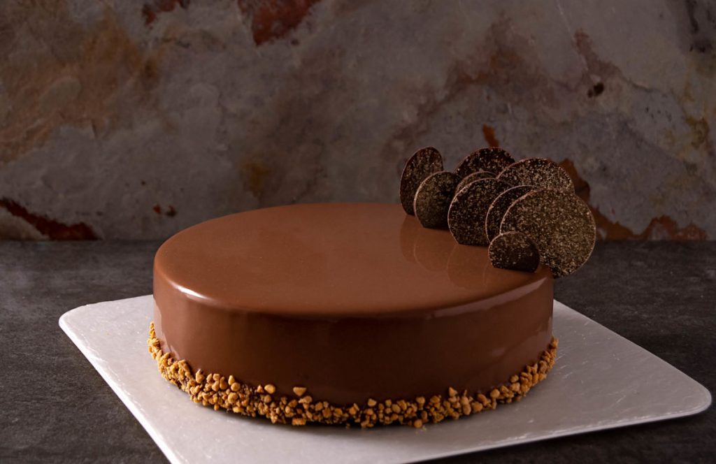 Peanut butter and raspberry entremet with a dark chocolate glaze