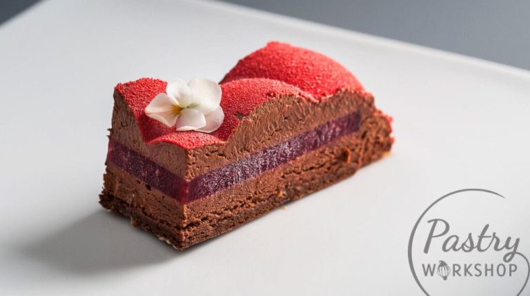 Rouge entremet with dark chocolate and raspberry, finished with a red velvet effect