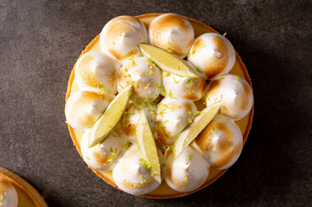 Slice of lemon meringue tart showing the cremeux