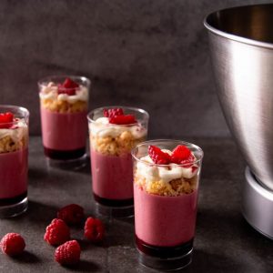 Raspberry mousse verrines with coconut crumble and fresh raspberries